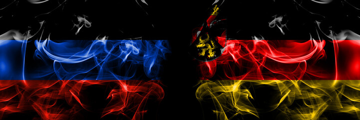 Donetsk People's Republic vs Germany, Rhineland, Palatinate flag. Smoke flags placed side by side isolated on black background.