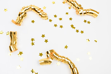 golden confetti on white background flat lay text place .