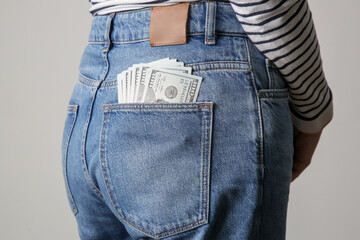Woman with full pocket of hundred dollar bills © triocean