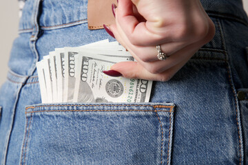 Woman with full pocket of hundred dollar bills