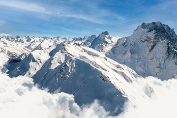 Fototapeta premium Beautiful view of a high mountain peak above the clouds 