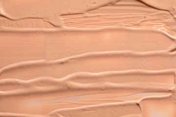 Beige nude liquid foundation texture, concealer smear smudge drop. Closeup macro. Cosmetic tonal makeup moisturizer, bb cream swatch sample.- Image