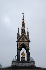 Fototapeta na wymiar Center Front Elevation Shot of Neo-Gothic Memorial to Prince Albert with motion blurred people in Hyde Park, Kensington, London, UK in winter 2022