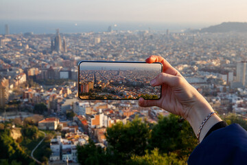 Photographing the panorama of Barcelona on a mobile phone.