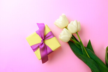Gift box and spring flowers on pink background. Stylish soft image of spring flowers. Happy womens day. Happy Mothers day.Hello Spring- Image