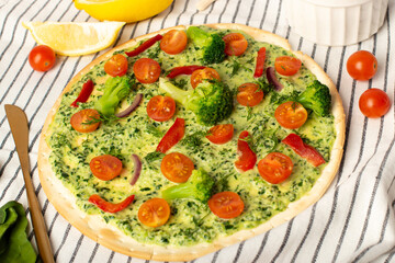 Composition with pizza, cherry tomatoes and fresh basil on light background