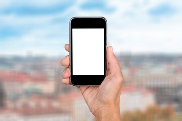 Human hand holding phone with blank screen and cityscape blur background