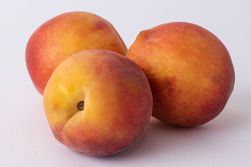 fresh peaches on a white meza