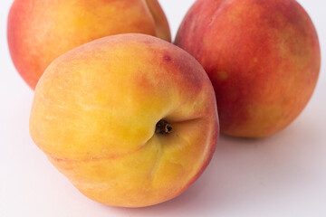 fresh peaches on a white meza