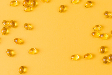 Fototapeta na wymiar Close up of oil filled capsules suitable for: fish oil, omega 3, omega 6, omega 9, vitamin A, vitamin D, vitamin D3, vitamin E - Image