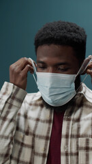 The guy takes off his mask, throws it away and shows that he is very pleased with that