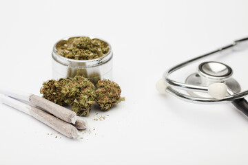 marijuana buds, grinder with joint,  phonendoscope, with white background.