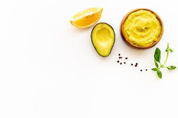 Bowl of guacamole dip with avocado and lime. Homemade guacamole concept