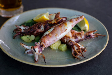 Grilled baby calamaris with spinach, potato and lemon