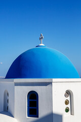 Fototapeta na wymiar The blue dome of Greek orthodox church on Santorini island.