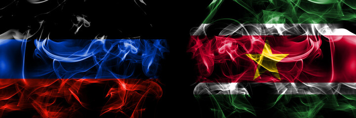 Donetsk People's Republic vs Suriname flag. Smoke flags placed side by side isolated on black background.