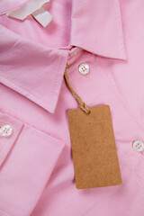 price tag hang over pink shirt close up view - Image