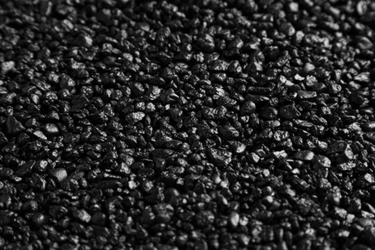 An image of real small black rock pebbles texture. 