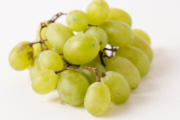 green grapes on white table, white background