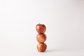 fresh red apples on a white table