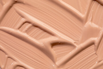 Beige nude liquid foundation texture, concealer smear smudge drop. Closeup macro. Cosmetic tonal makeup moisturizer, bb cream swatch sample.- Image