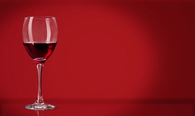 Red wine in the glass on the desk over red background