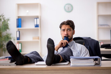 Young male employee working in the office