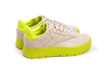 neon-soled sneakers on white background - Image