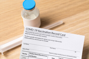 Syringe and vaccine vial for corona virus are on medical form required for travel and tourism. -...