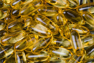 Close up of  oil filled capsules suitable for: fish oil, omega 3, omega 6, omega 9,  vitamin A, vitamin D, vitamin D3, vitamin E - Image