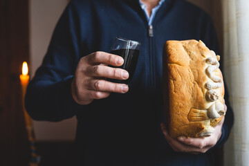 Family's man father hold patron saint celebration A homemade Slava cake bread in hands of man with...