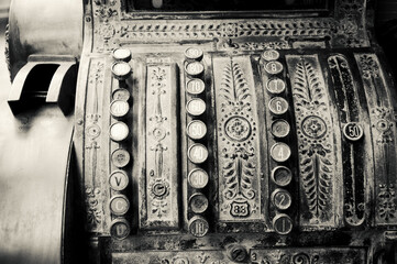 Antique rusty cash register. Business concept. Black white historic photo