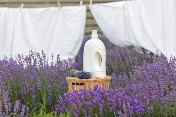 Fabric softener with lavender scent. Fragrance in a field with purple flowers.