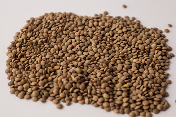dried brown lentils scattered over each other