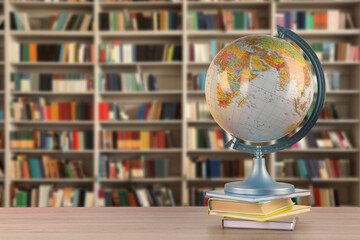 Globe and books on wooden table in library. Space for text