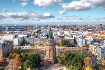 Autumn aerial cityscape of Mannheim city, Baden-Württemberg, Germany. Friedrichsplatz with the Mannheim Water Tower (Wasserturm) in the foreground  - obrazy, fototapety, plakaty