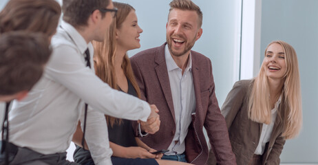 business colleagues shaking hands in the lobby of the business center