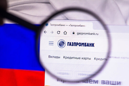 February 22, 2022, Brazil. In this photo illustration, the russian bank logo Gazprombank (GPB) seen displayed on a computer screen through a magnifying glass.