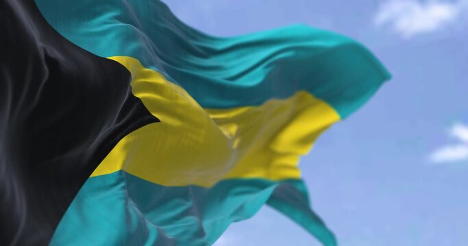 Detail of the national flag of Barbados waving in the wind on a clear day.