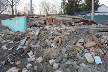 a pile of garbage from old bricks and gray earth on the street