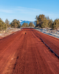 red cinder dirt road through rural country