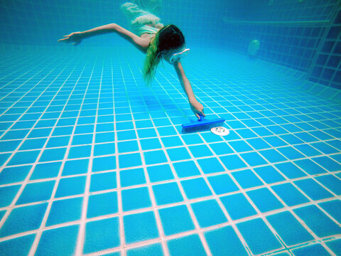Picture of underwater pool cleaning.Service and maintenance of the pool.