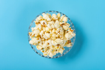 top view bowl of popcorn on a blue background