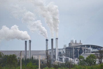 White smoke comes out from smokestacks or exhaust pipes in the factory chimneys emit water vapor which condenses into a whitish cloud before evaporating, Steam sugar factory, electricity generation