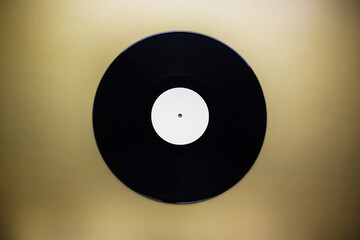 Classic vinyl record close-up on a yellow background, obsolete data storage, music