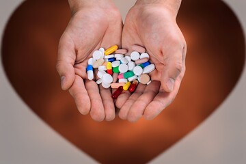 Doctor's hand holding a set of medical pill