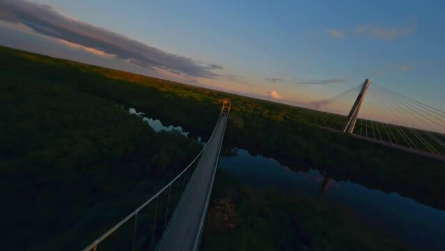 Puente Mauricio Baez And Puente Metalico de la Cementera Over The Higuamo River At Dusk In Dominican Republic. - aerial FPV