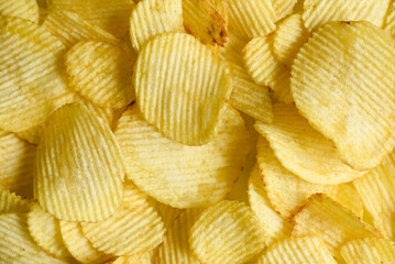 Potato chips texture background, Corrugated crispy potato chips snack - top view