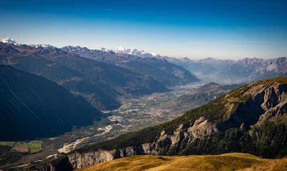 Fotobehang Overlooking the Valais Valley in Switzerland, lined with the Alps on both sides, Seen from the Torrent region © Maik