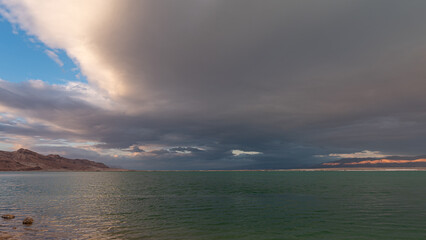 Fototapeta na wymiar Panorama of the brilliant colors of the Dead Sea and the clouds on a Winter's day in Israel. 